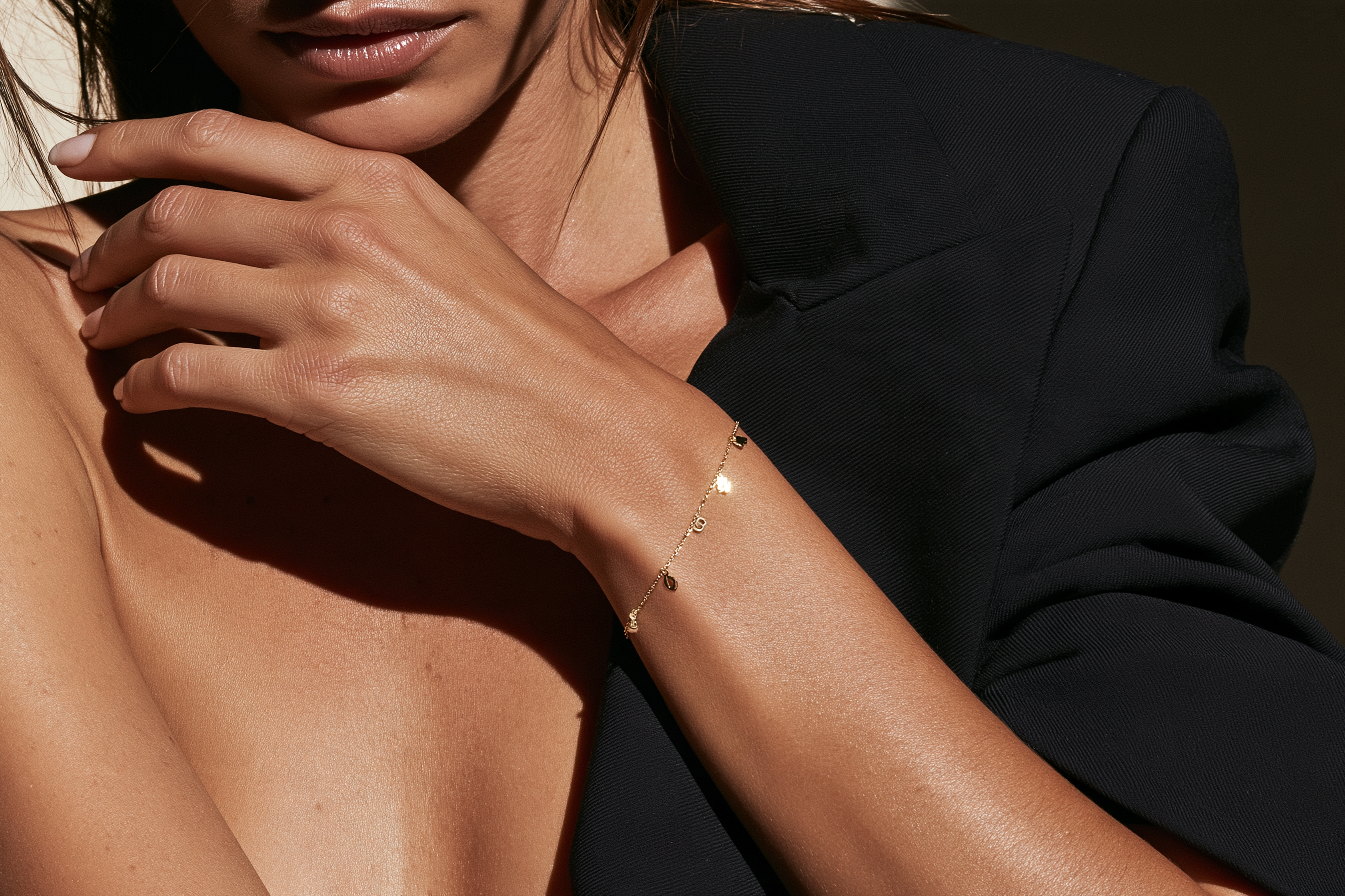 Personalized gold charm bracelet featuring letter, number and symbolic charms