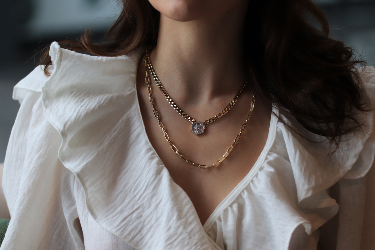 Woman wearing gold jewelry styled with an engagement dress